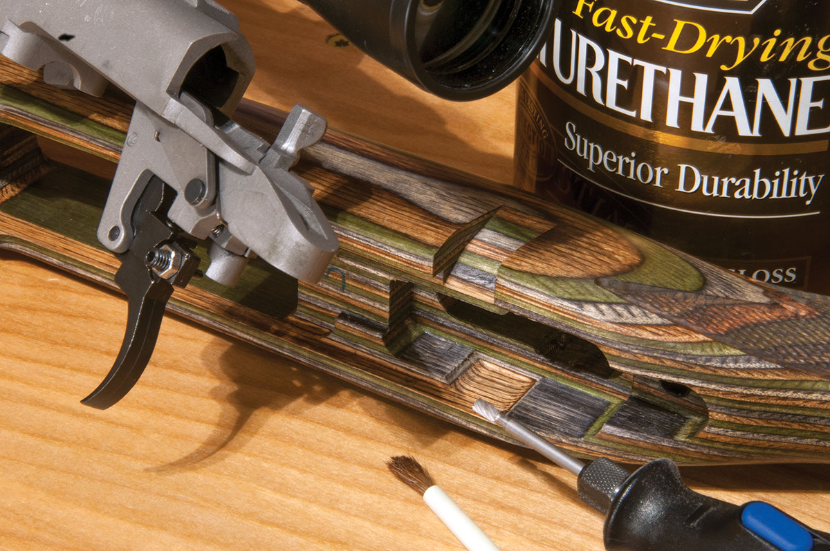 Installing a Rifle Basix RU-R (Ruger rimfire) adjustable trigger is simple, though its safety screw may contact the inside of a wood stock. To prevent binding on this 77/17 17 Hornet, a Dremel tool was used to grind a shallow trough for the safety screw, and the ground-away portion was sealed with a couple of thin coats of polyurethane.