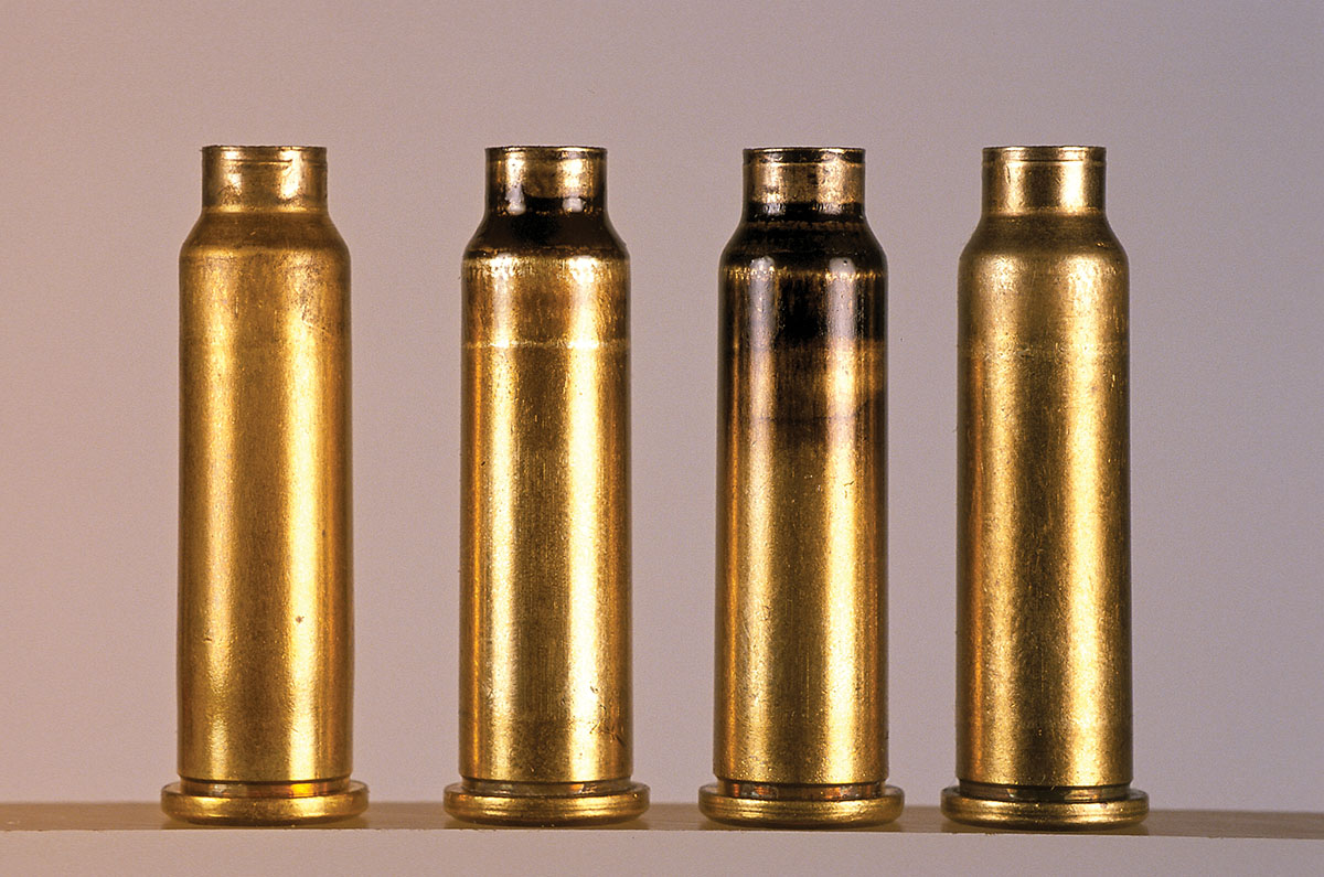 Using the method of neck sizing only, cases include (left to right) a newly fired case, a case  smoked with a candle, a neck sized case and a finished version.