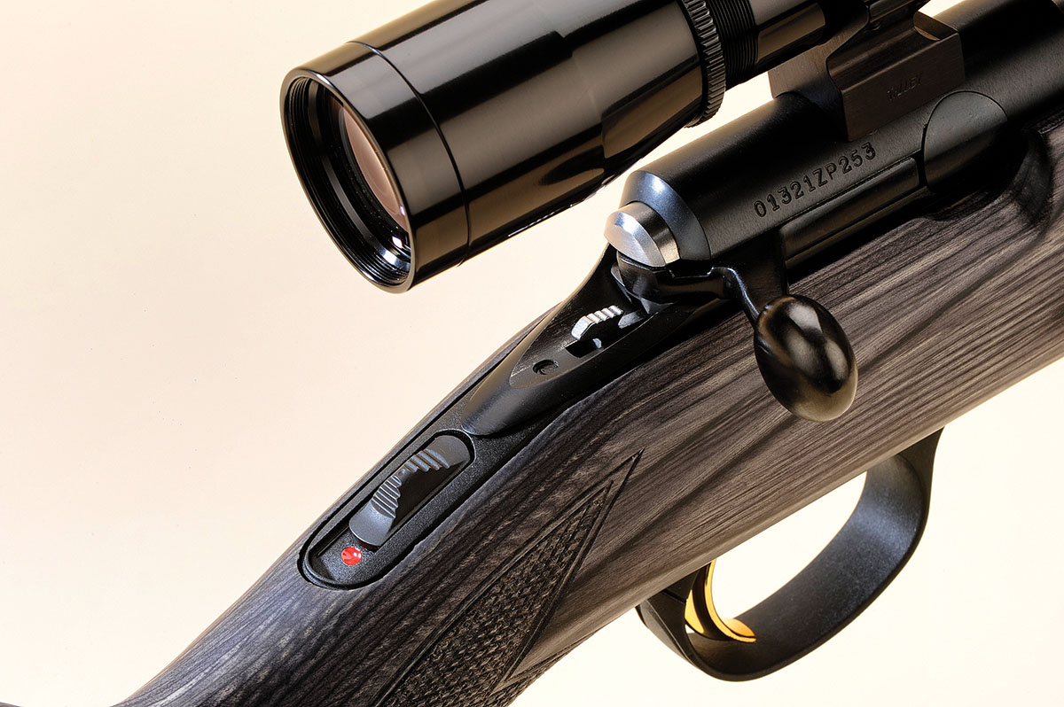 The tang is still the best place for a safety lever on any rifle. The small metal piece sticking out under the shroud is used to remove the bolt for cleaning.