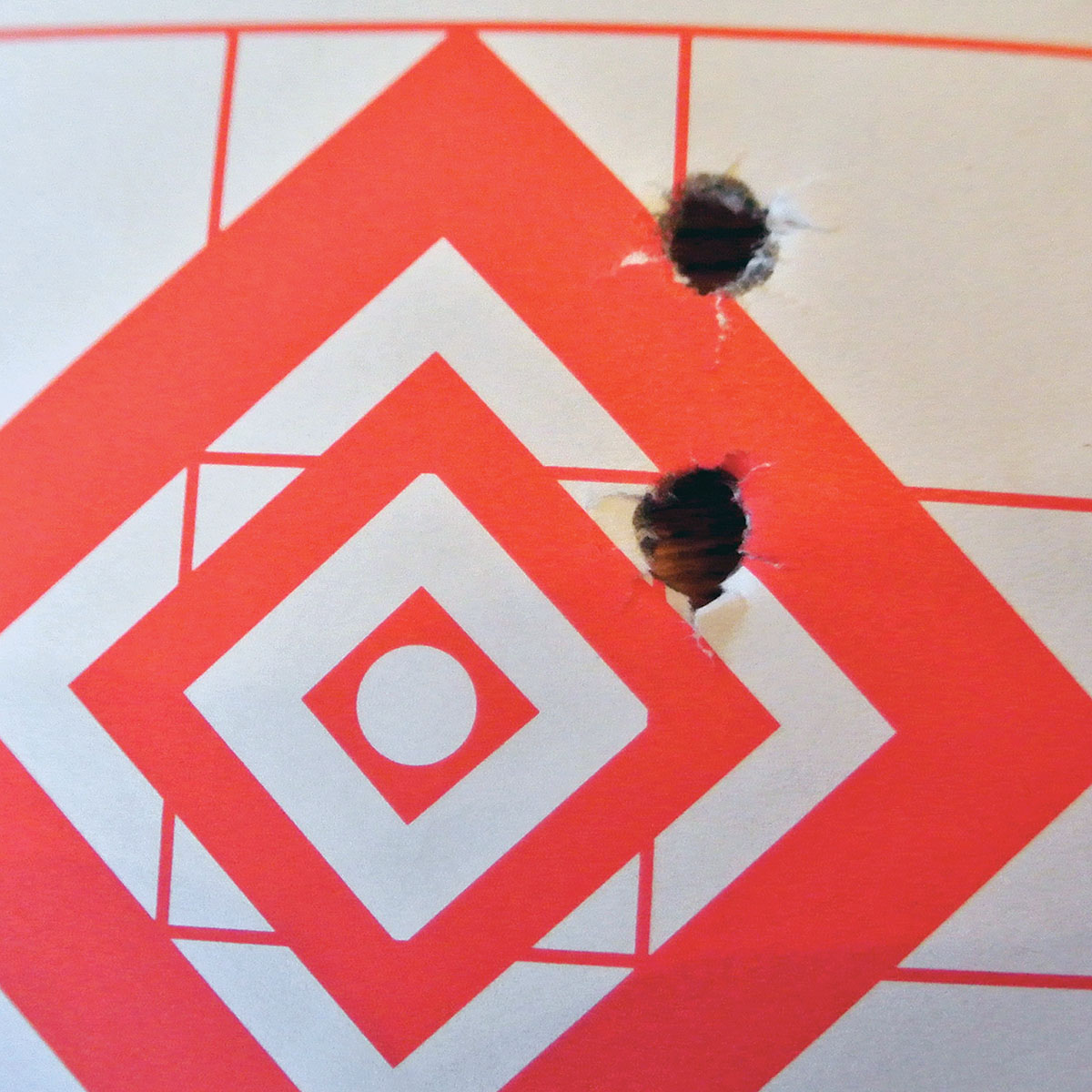 The first test group produced this unusual two-hole, three-shot group. The first shot went into the lower hole, the second into the top and the third almost perfectly back into the first hole. The second group looked much the same. The rifle was loose in its bedding.