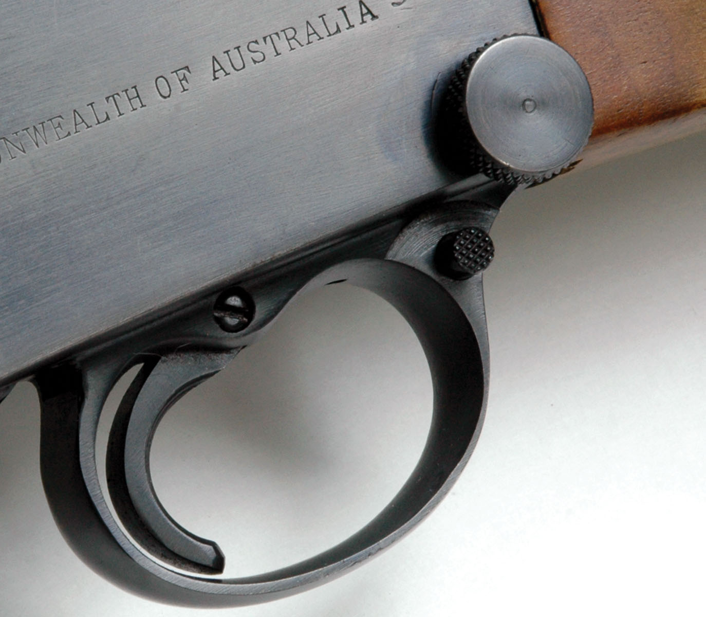 The original split pin had to be driven from the receiver for removal of the inner frame and its components for cleaning, so it was replaced by a threaded bolt with a large knurled head. The two-position, trigger-blocking transverse safety in the front of the trigger guard was also added.