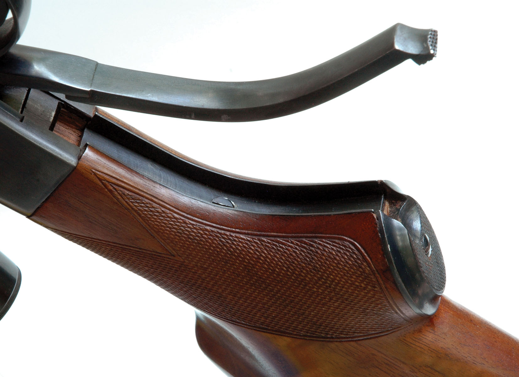 A push on the checkered tab of the underlever moves it forward to hinge down the front of the breech bolt for exposing the chamber for loading.