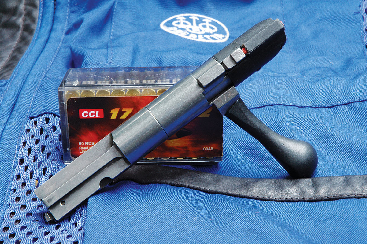 Breech lockup is accomplished by contact of the root of the bolt handle with the front of the receiver bridge and by an adjacent lug that engages a recess in the floor of the receiver.