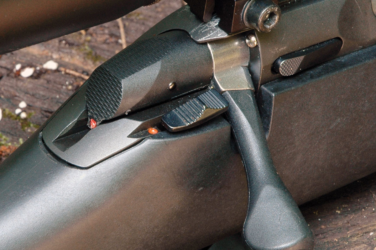 Shown here are the red cocked firing pin indicator, the two-position safety slide and the bolt release forward of the bolt handle.