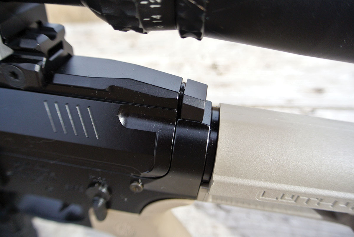 In most AR-style firearms, the gas key raceway is covered by the charging handle and helps to protect the shooter from liberated gas. Because the MT-15 uses  a side-mounted charging handle, a threaded block had been added to the action to seal the raceway. The heavy gasket between the block and receiver effectively blocks blowback.