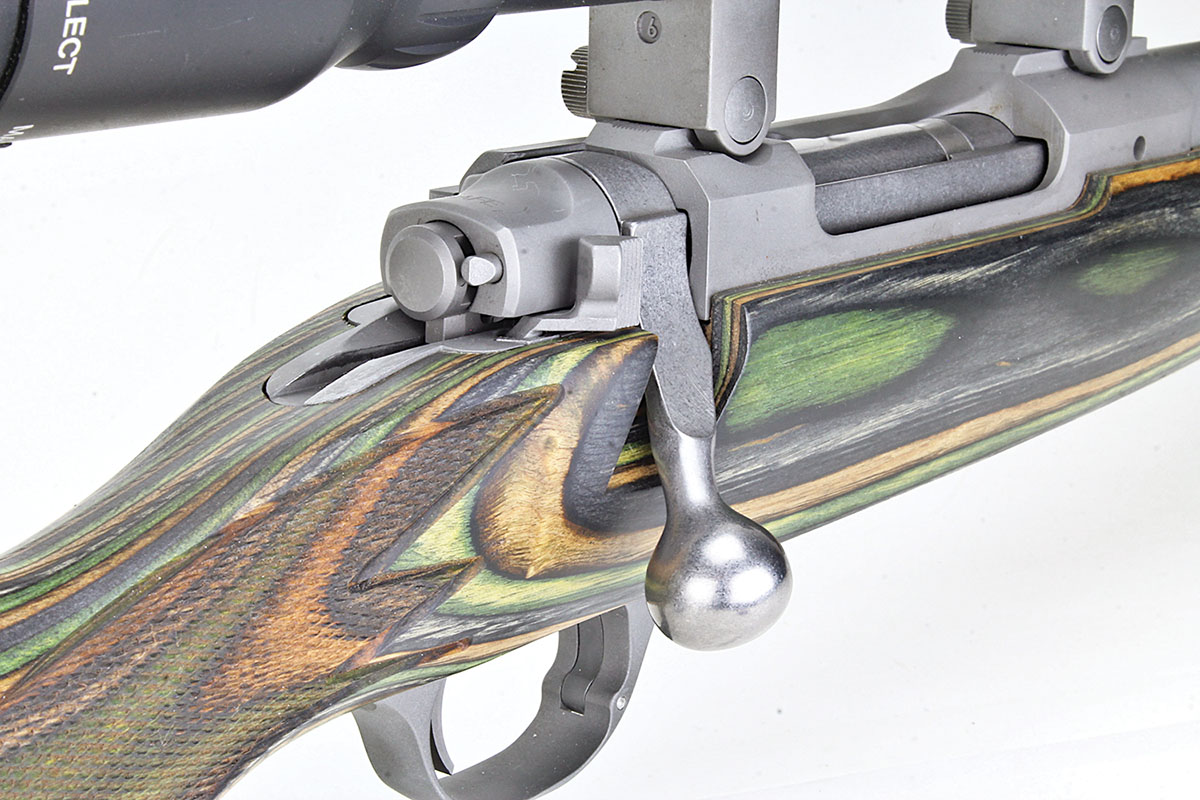 Cut checkering is almost visually lost in the colors of the laminated stock. Here the Winchester Model 70-style safety is evident.
