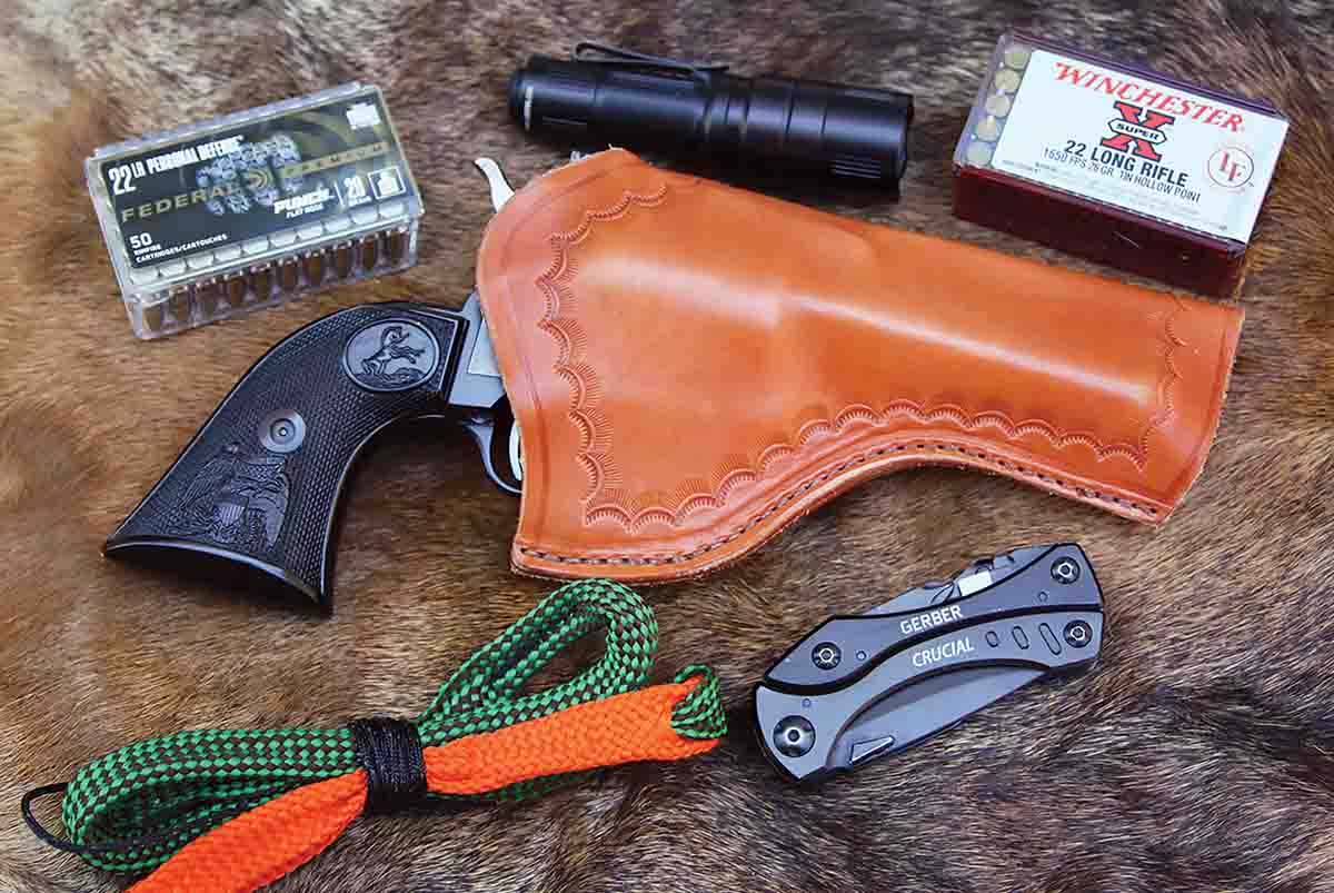 If there’s a chance a hunter will be staying out overnight, they can pack their Colt in a comfortable and accessible holster from Simply Rugged and include a couple extra compact tools like a boresnake and a small Surefire flashlight.