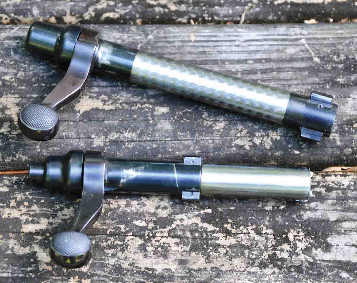 The 40-XB bolt (top) is basically a hand-selected Model 700 bolt with dual- opposed locking lugs at the front. Rifles in .22 Long Rifle have a two-piece bolt with the non-rotating front section containing a pair of extractors while the rotating rear section has opposed locking lugs.