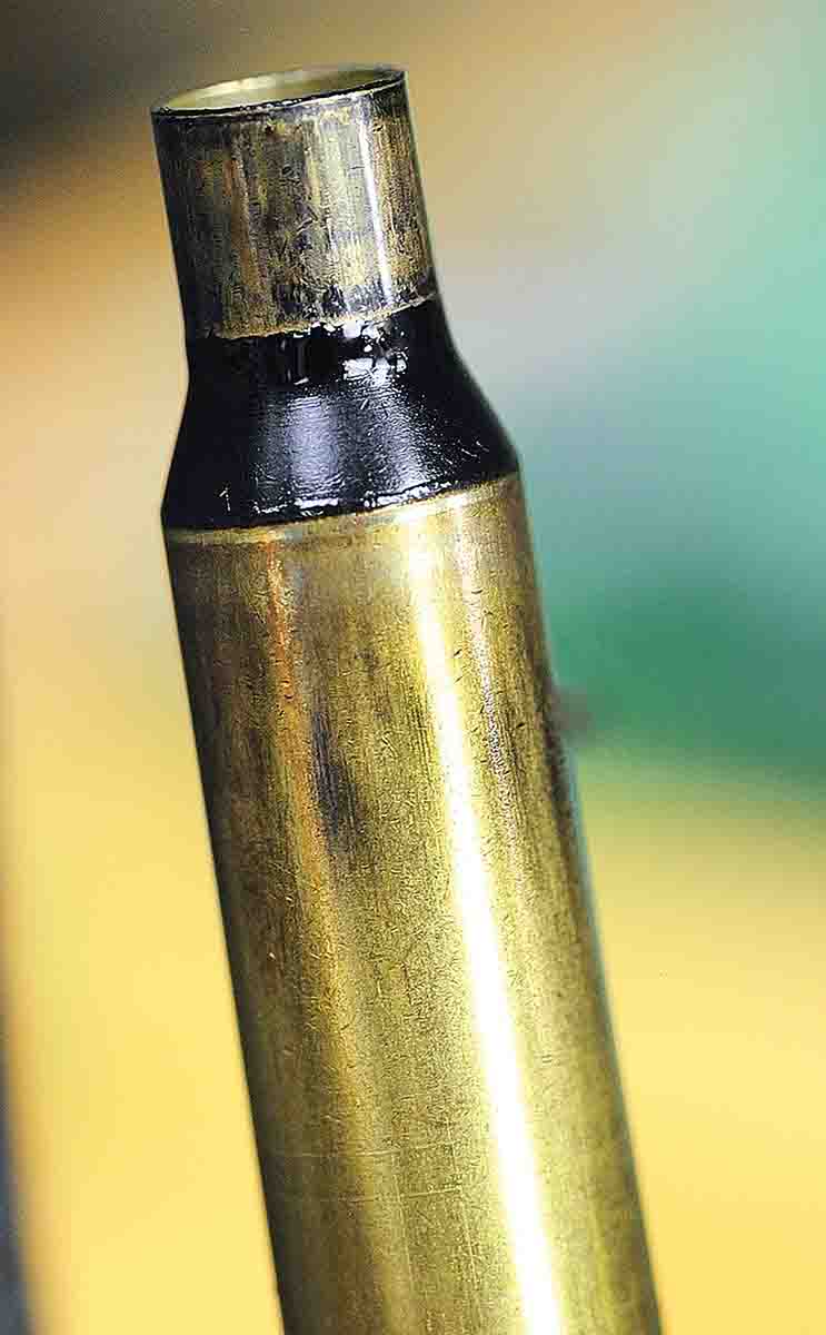 The effects can be seen after smoking the case with a candle to show the movement of the die for neck sizing. Only the neck is touched and not the body of the fireformed case.