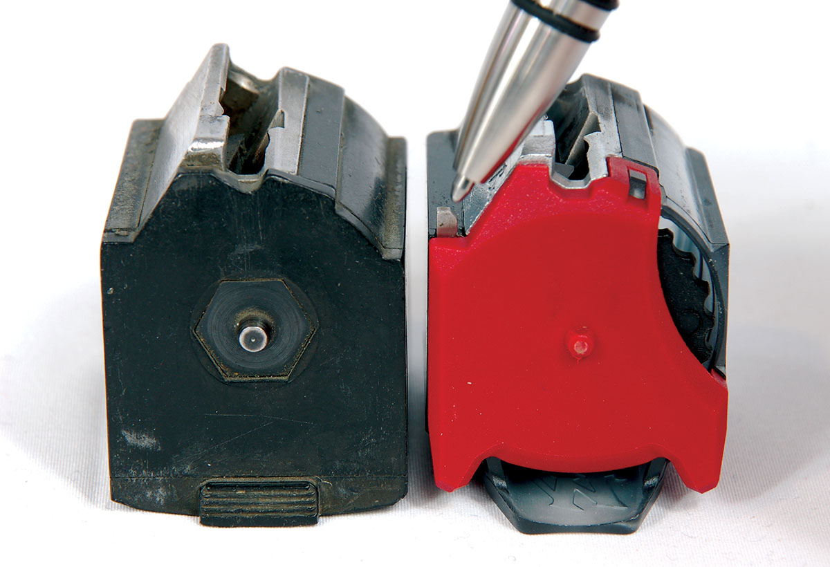 The pointer indicates the Winchester magazine “last shot bolt hold-open activator,” which is not present on the Ruger-type magazine on the left. Note the cartridge follower load/unload toothed wheel on the far-right side of the Wildcat magazine.