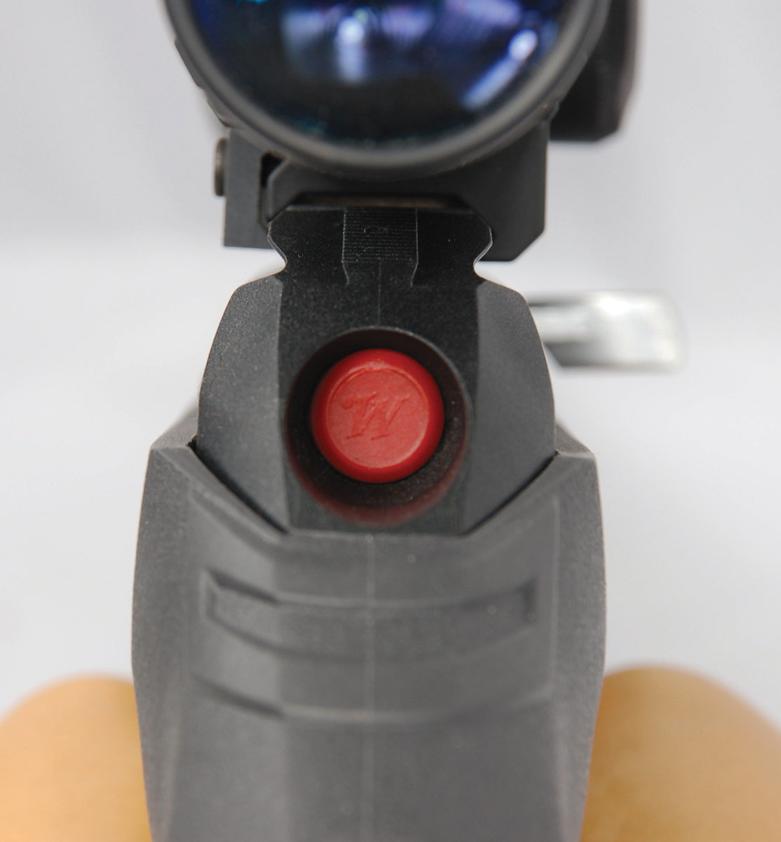 A push of the red disassembly button drops the lower receiver group and action components out of the bottom of the stock. The button’s hole in the upper receiver can then be used as the cleaning rod port.