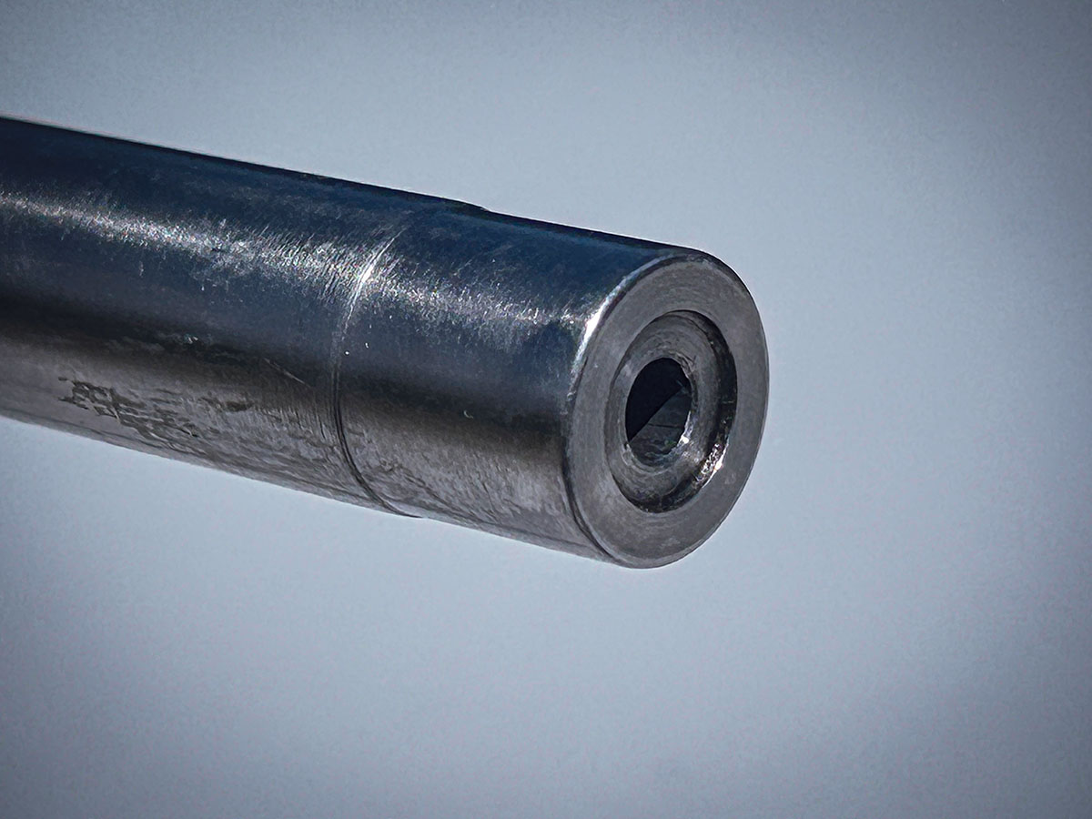 Manufactured during the Clinton-era Federal Assault Weapons Ban, the Bushmaster’s 24-inch barrel is unthreaded. Its recessed target crown is one of several features incorporated into the rifle to promote accuracy.